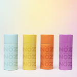 Load image into Gallery viewer, Four boldly colorful containers of Nöz dermatologist recommended zinc oxide Nözscreen sunscreen 
